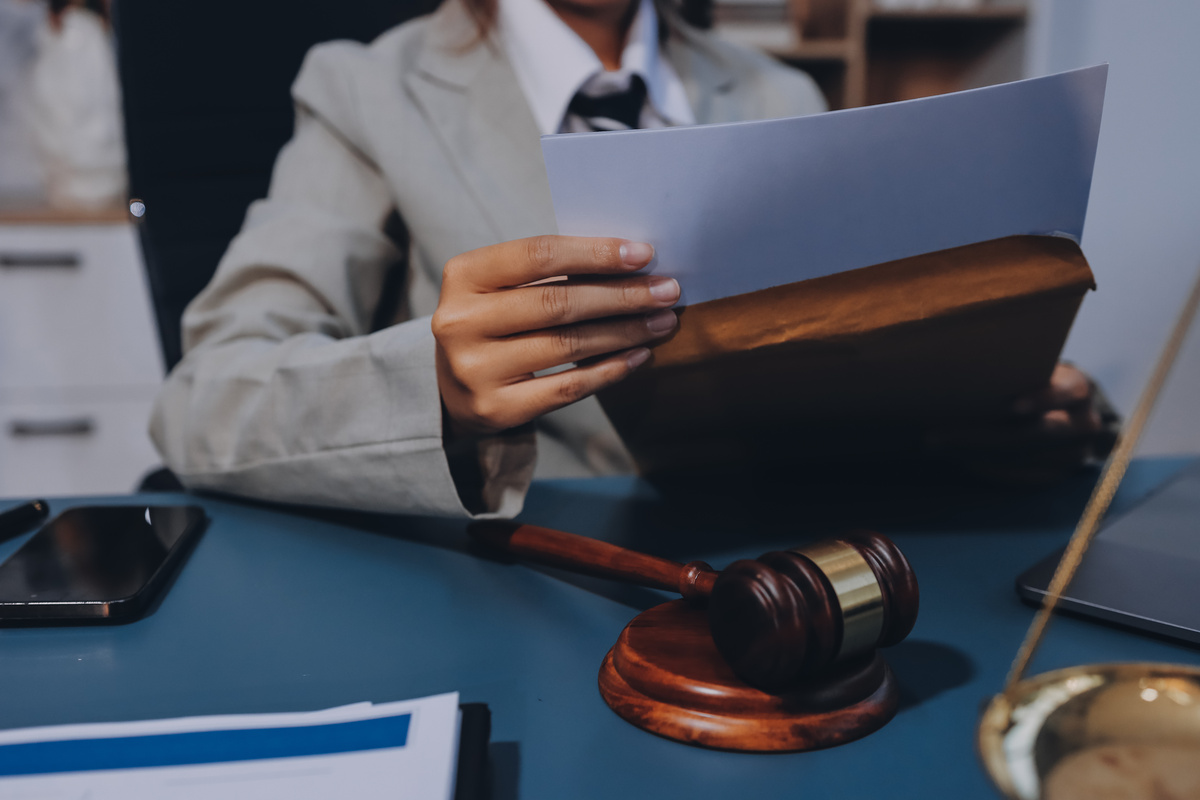 Judge gavel with Justice lawyers having team meeting at law firm background. Concepts of Law and Legal services.